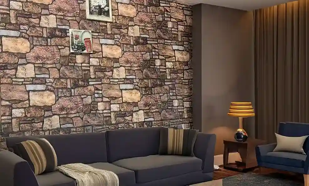 Living room with a faux stone wall, a sofa, an armchair, and warm lighting